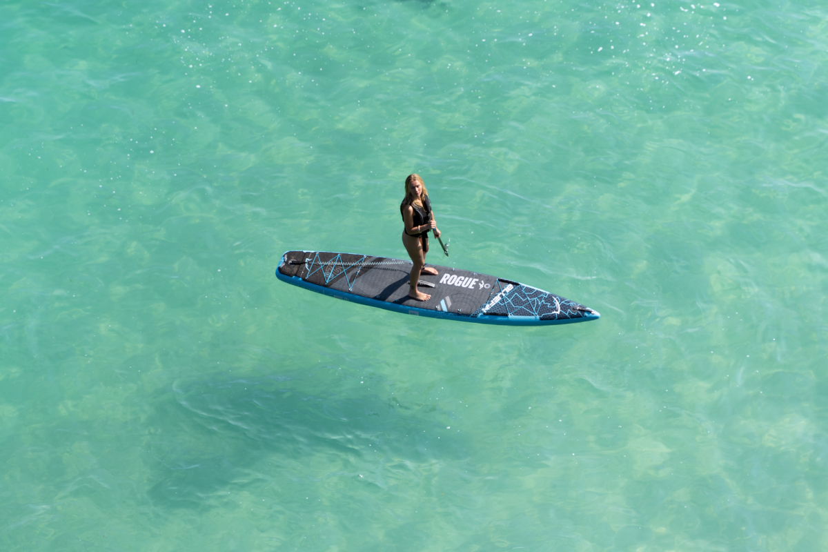 woman stood on paddleboard in the ocean