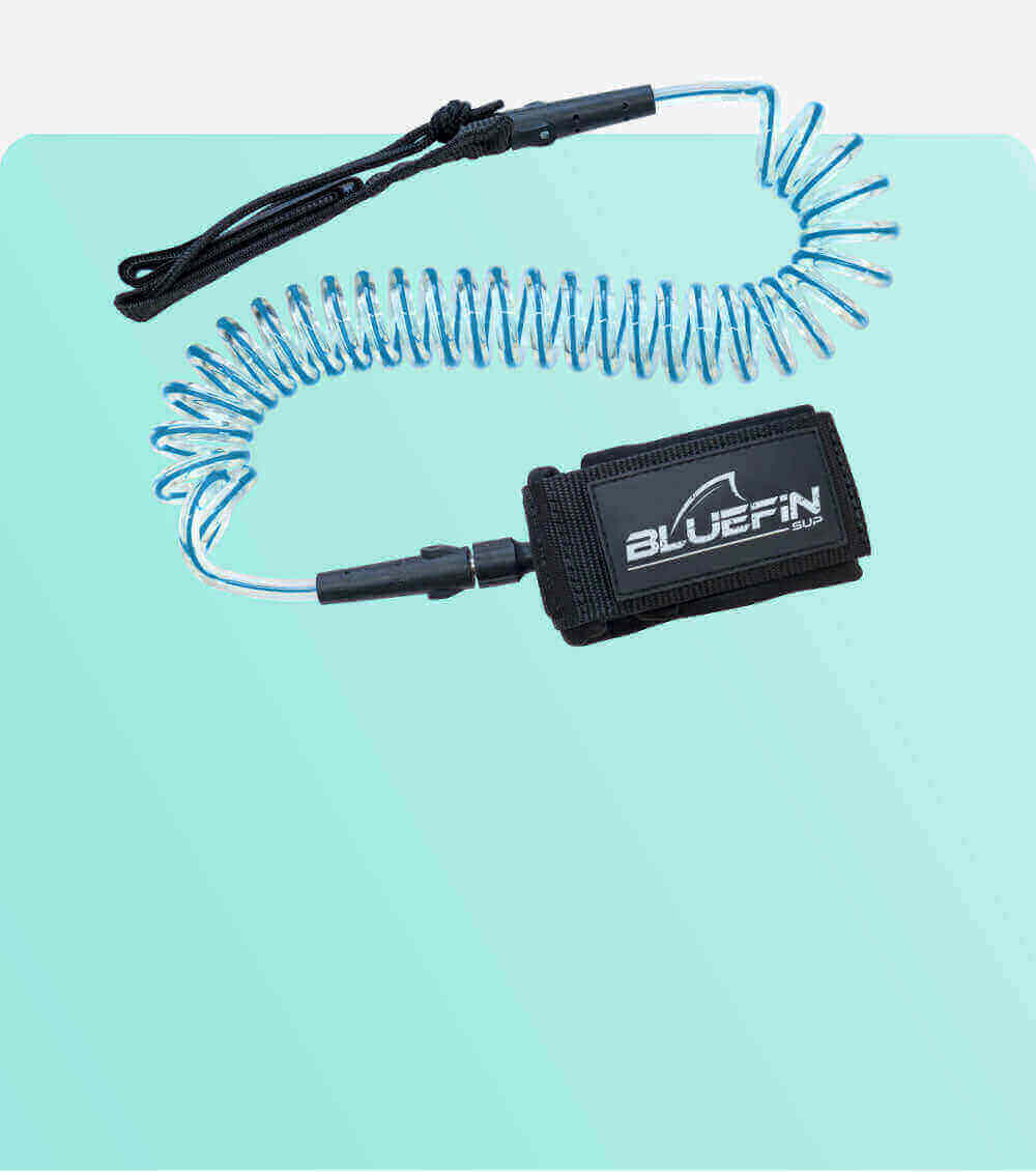 Coiled safety leash with black strap and blue cord, designed for paddleboarding use