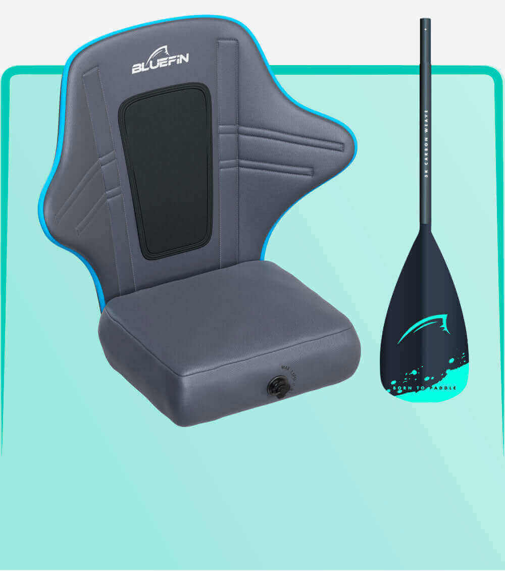 Gray inflatable seat with blue trim and back support next to a black paddle with teal accents