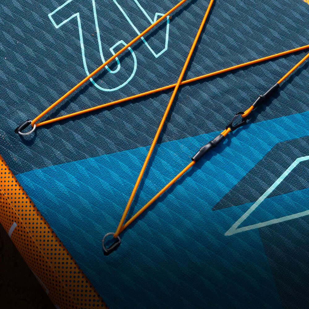 Textured inflatable paddleboard with orange bungee cords and metal D-rings for gear attachment