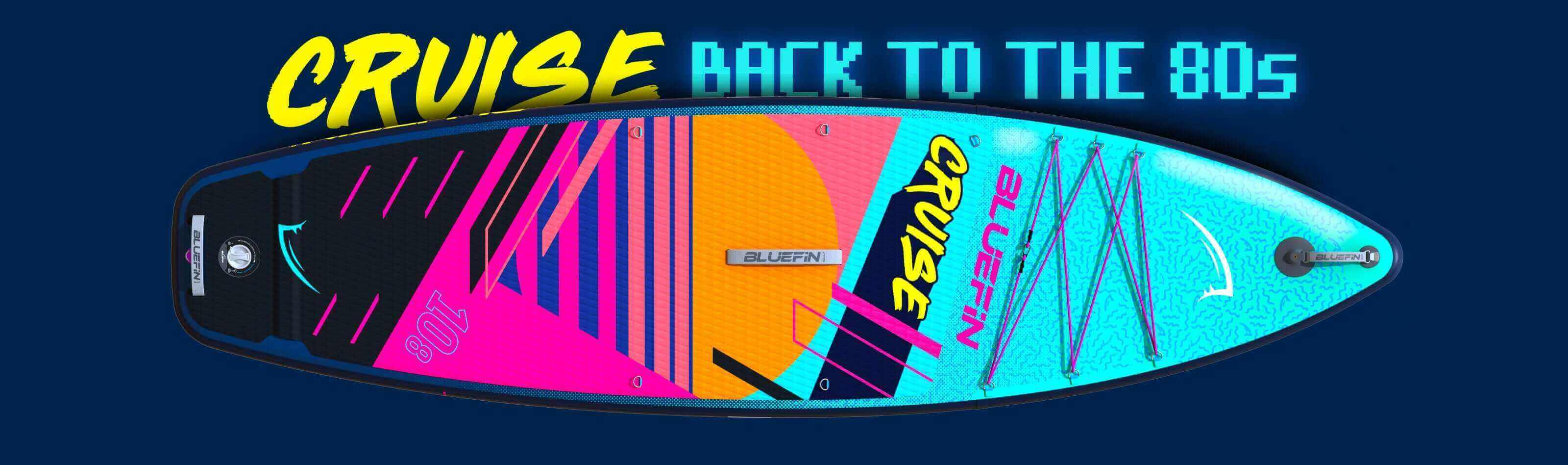 Colorful inflatable paddleboard with textured deck, center fin, and branding in vibrant 80s style.