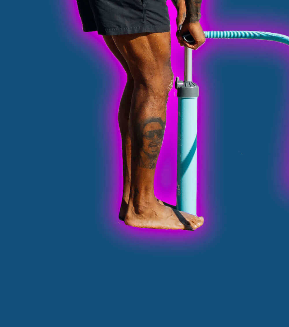 Person with a tattoo on their leg using a blue pump on a dark background