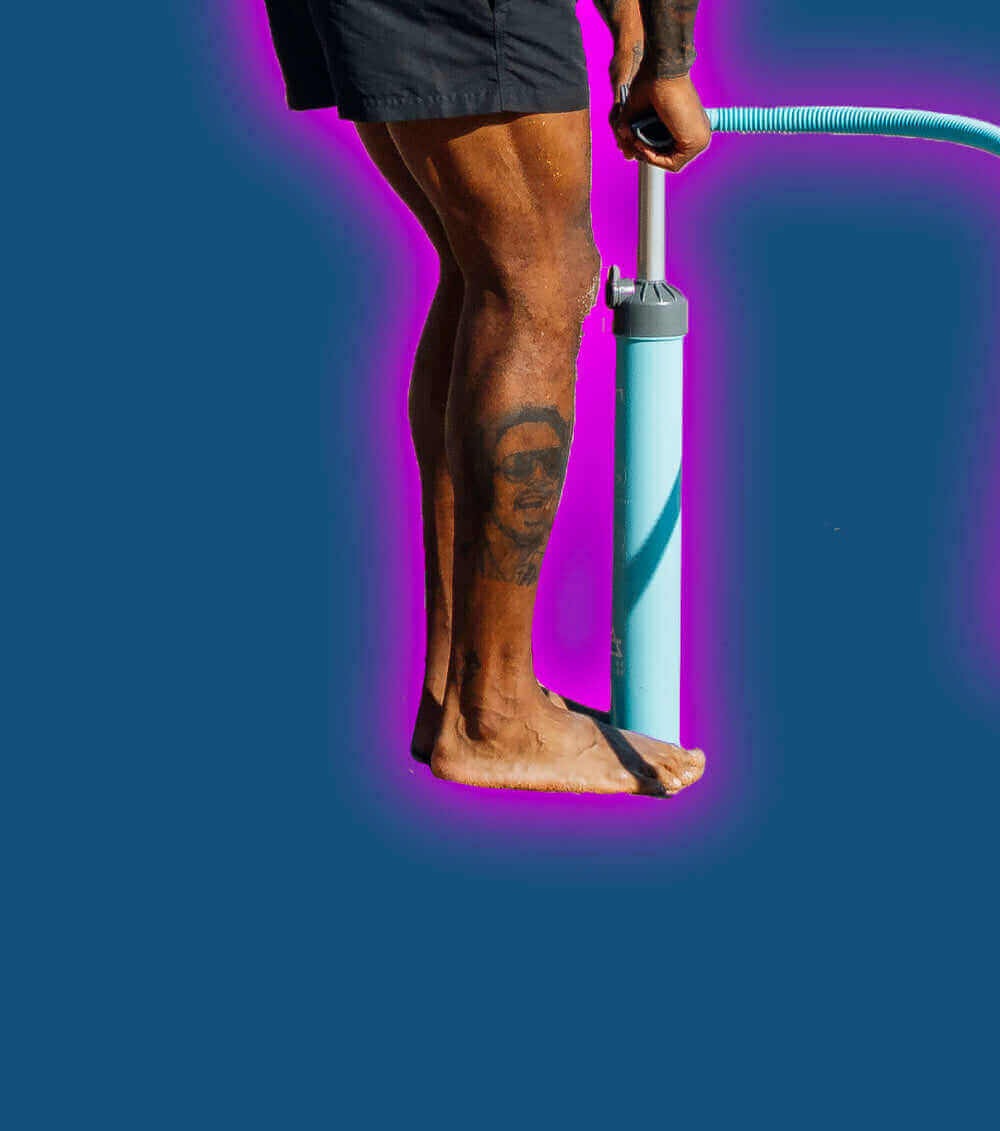 Person with a tattoo on their leg using a blue pump on a dark background