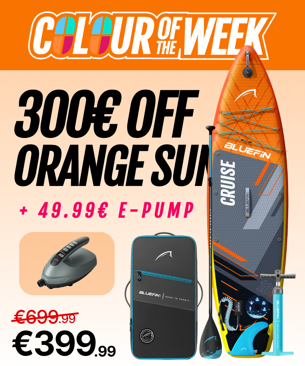 Inflatable orange paddleboard with textured deck, fin, pump, and carrying bag, marked down to €399.99