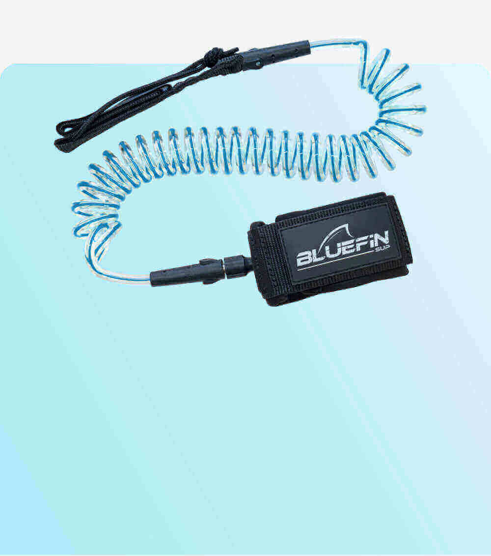 Coiled safety leash with black strap and blue cord, featuring a BLUEFIN SUP logo on the attachment.