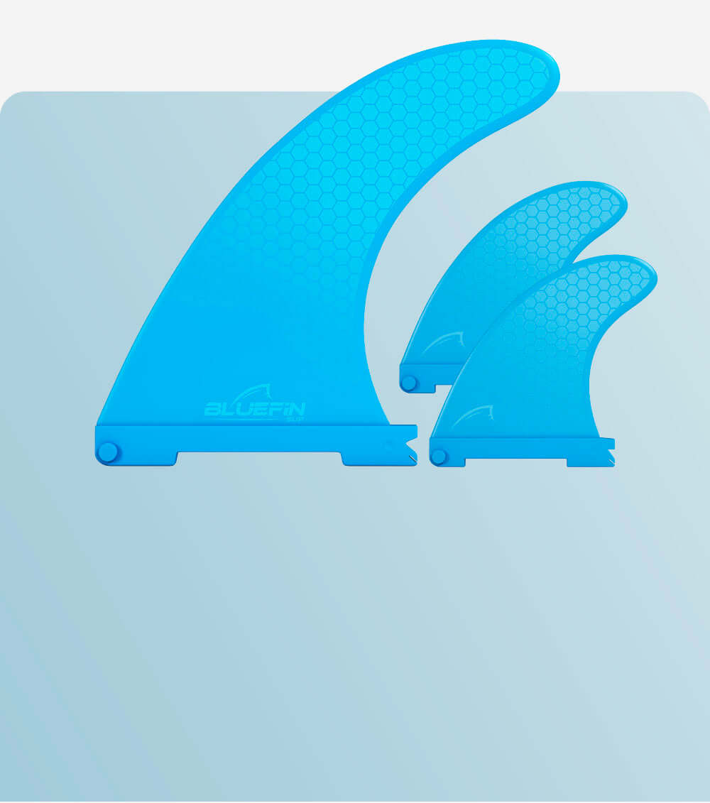 Three blue surfboard fins with a honeycomb pattern, varying in size, displayed on a light background.
