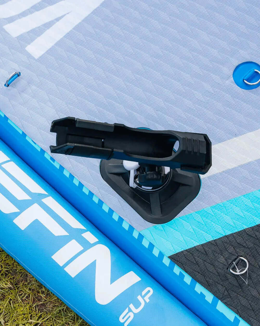 Inflatable paddleboard featuring a center fin, textured surface, and inflation valve detail