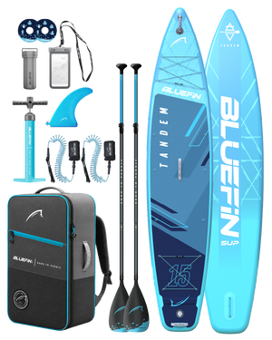 Inflatable tandem paddleboard in blue with two paddles, pump, fin, backpack, and accessories.