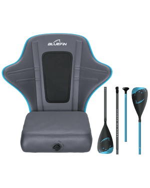 Gray padded kayak seat with blue trim, adjustable straps, and two paddles beside it.